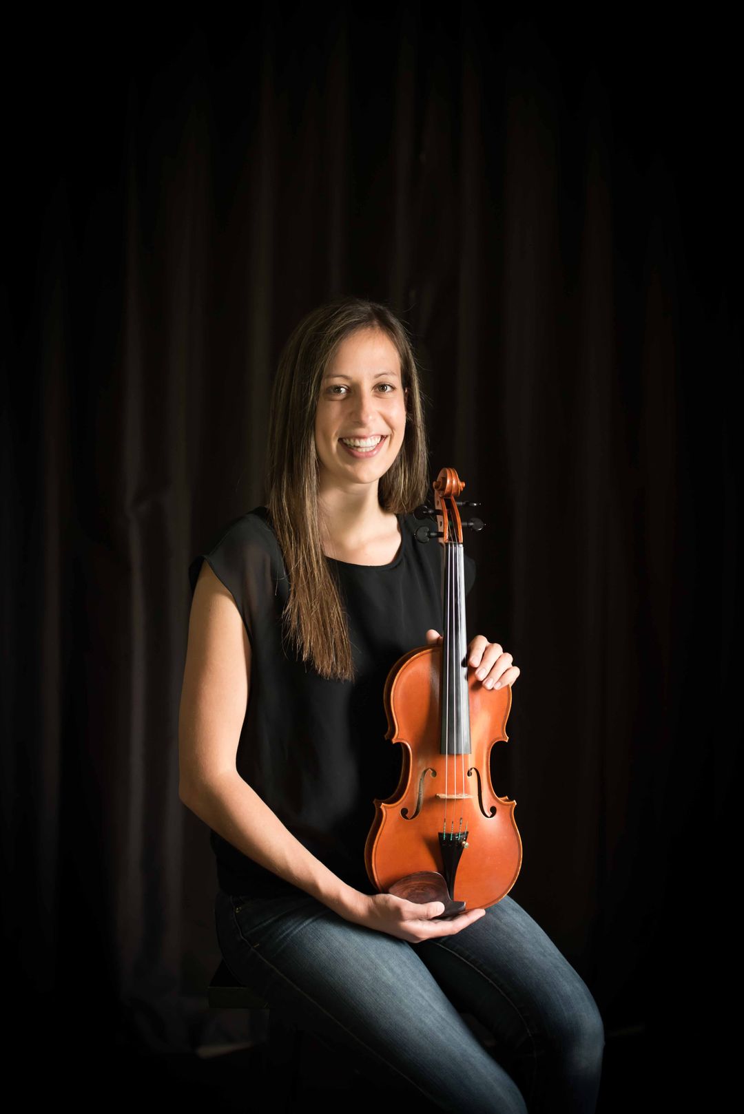 Professional violinist and pianist Laila holding violin